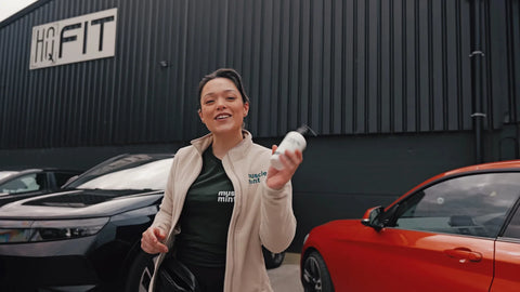 Zolene holding a bottle of Muscle Mint outside HQfit gym in Bangor on the day of its HYROX simulation
