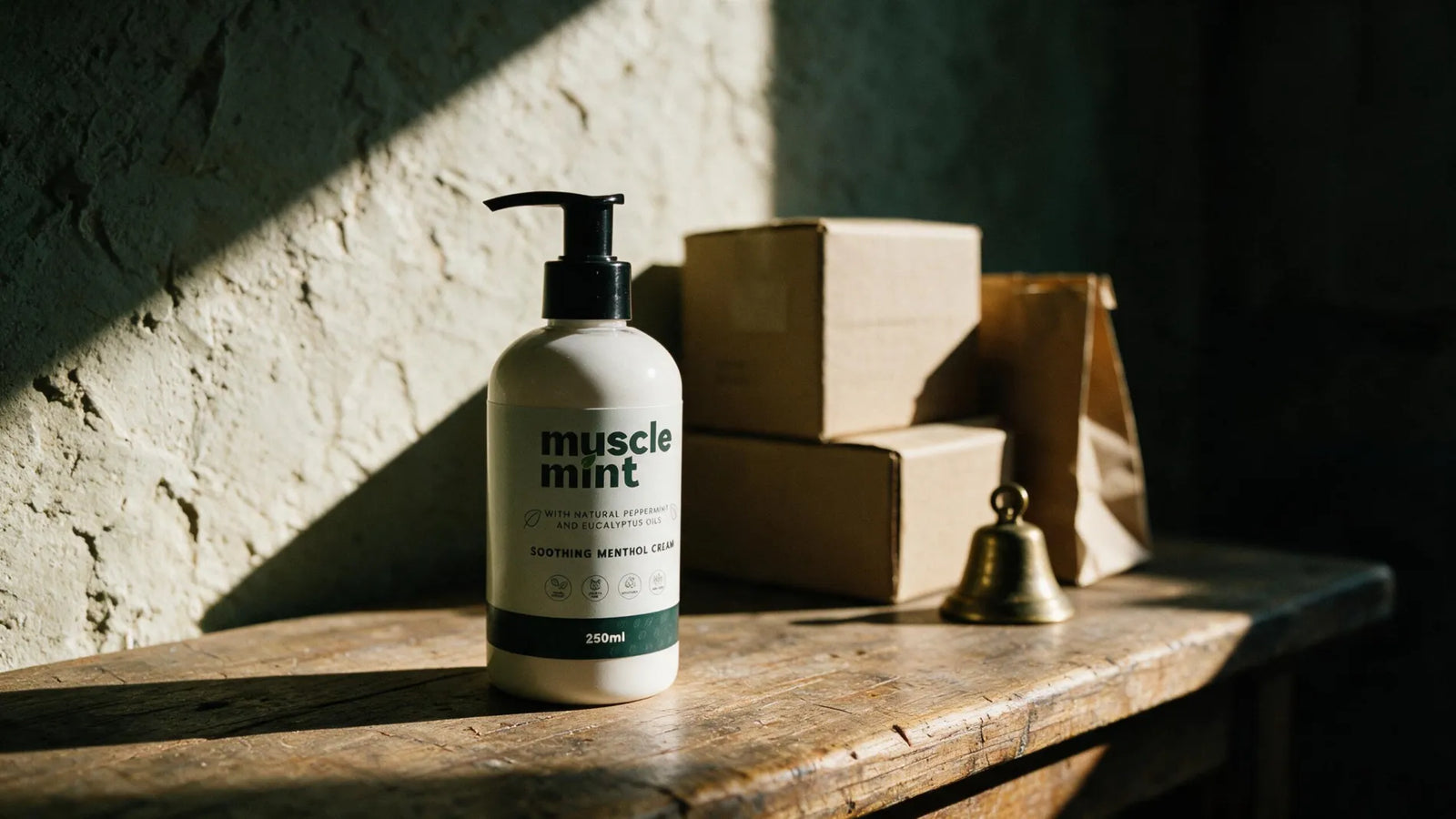A Muscle Mint bottle on the counter of a small independent shop, beside stock boxes in morning light