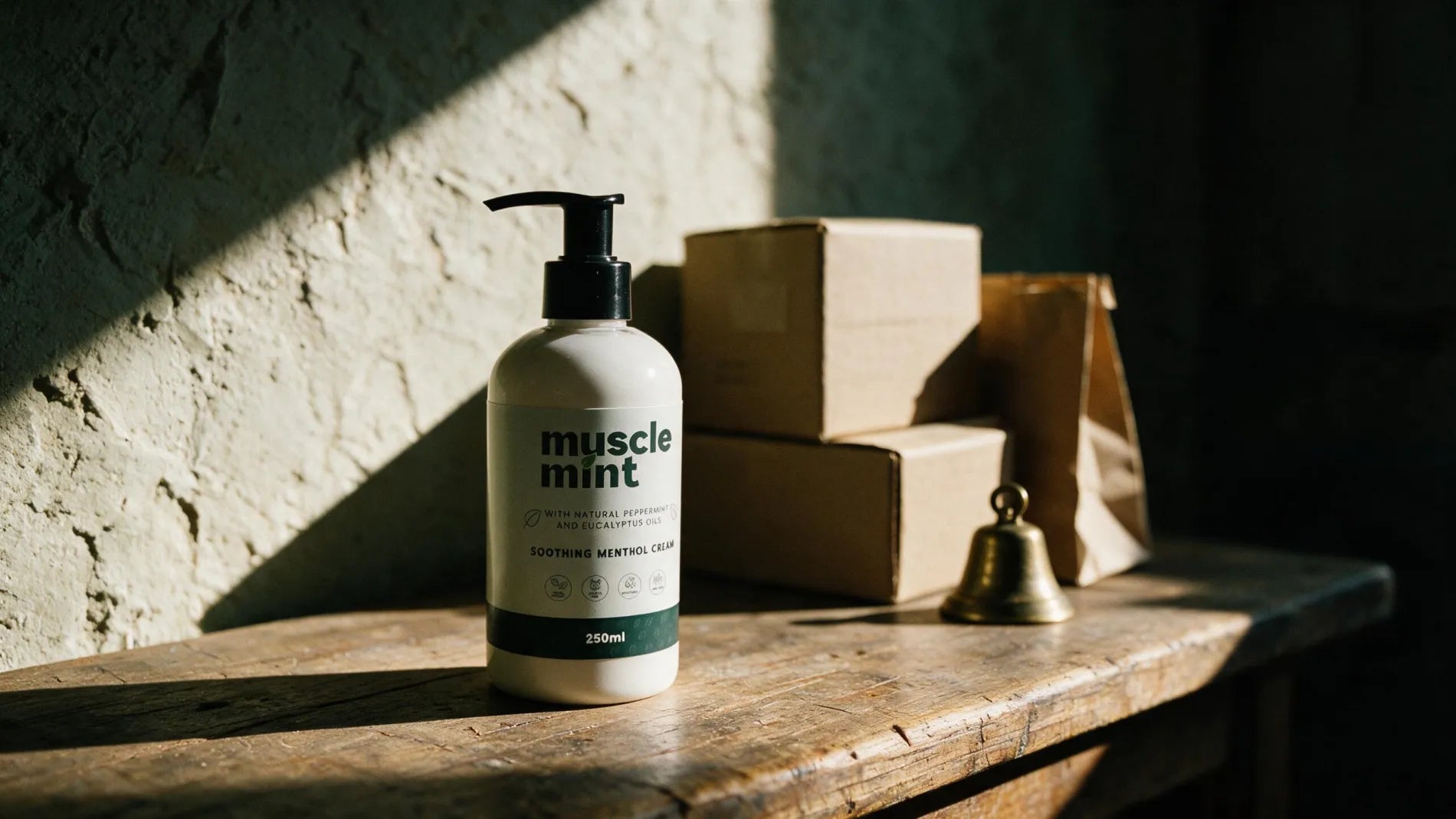 A Muscle Mint 250 ml bottle on the timber counter of a small independent shop, beside stock boxes in morning light