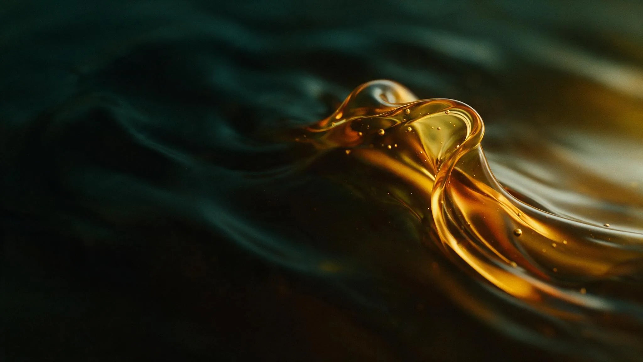 Golden ribbon of sunflower oil folding through deep shadow, amber editorial background